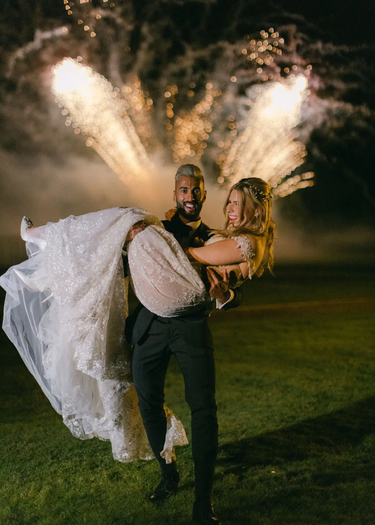 Groom holding bride in front of fireworks - Buckinghamshire wedding