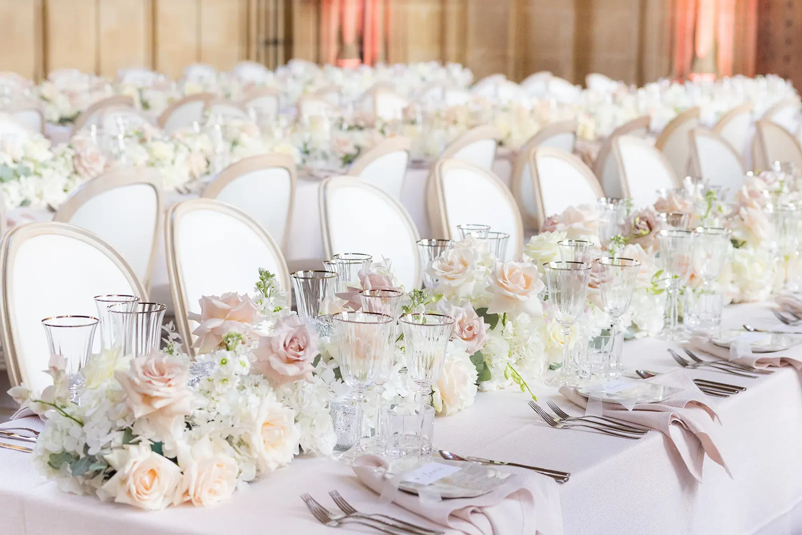 Long tables with blush and white flowers at Bodeleian Libraries