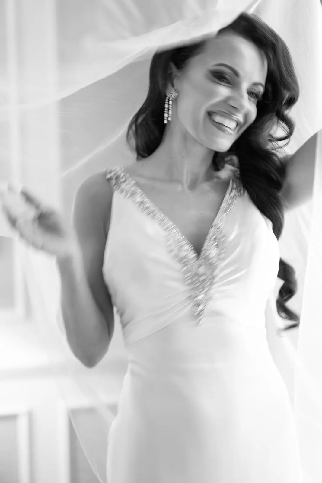 Bride at Four Seasons Hampshire smiling and happy under her veil - Luxury Wedding & Events Planner