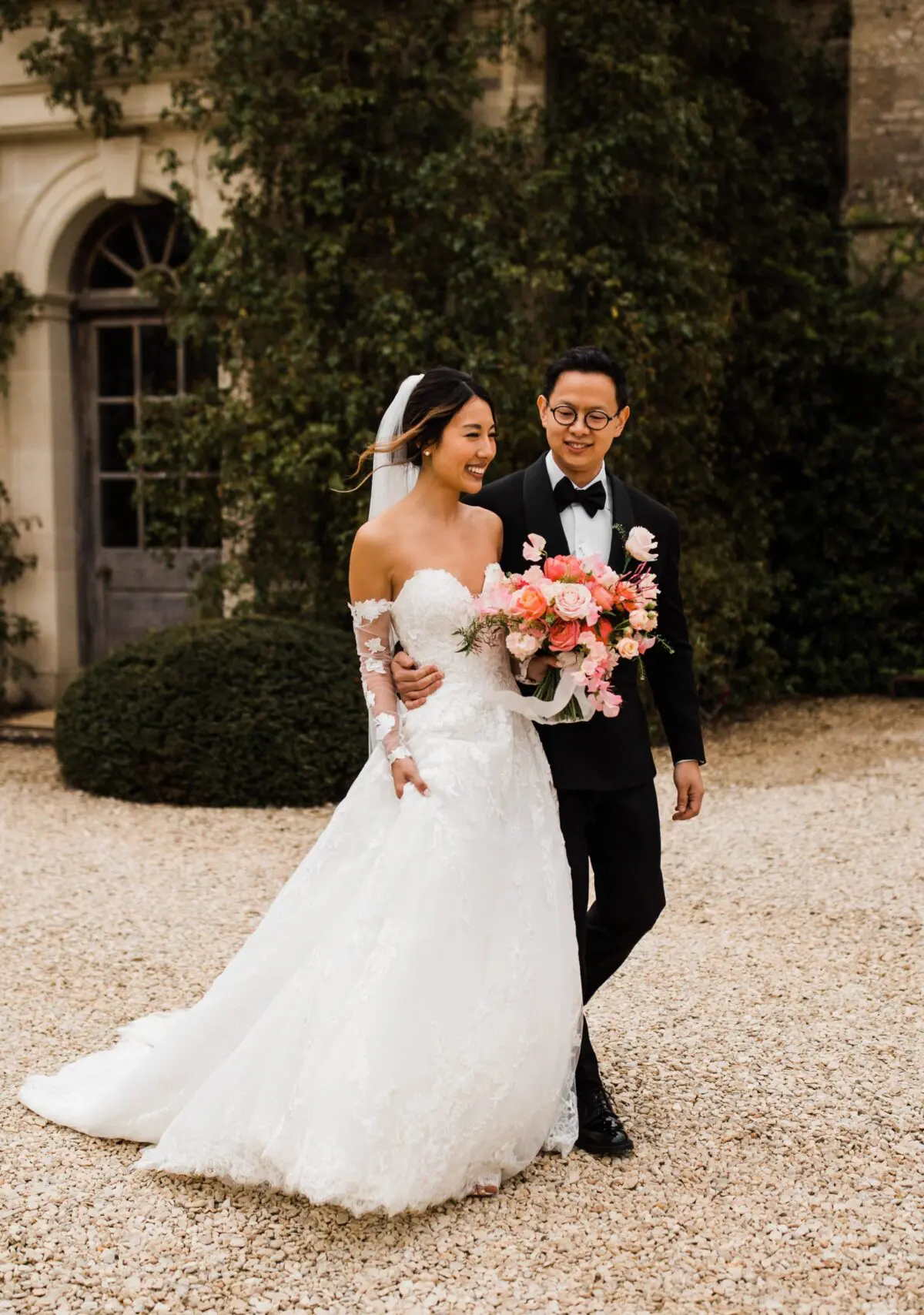 bride and groom walking outside - wedding designer