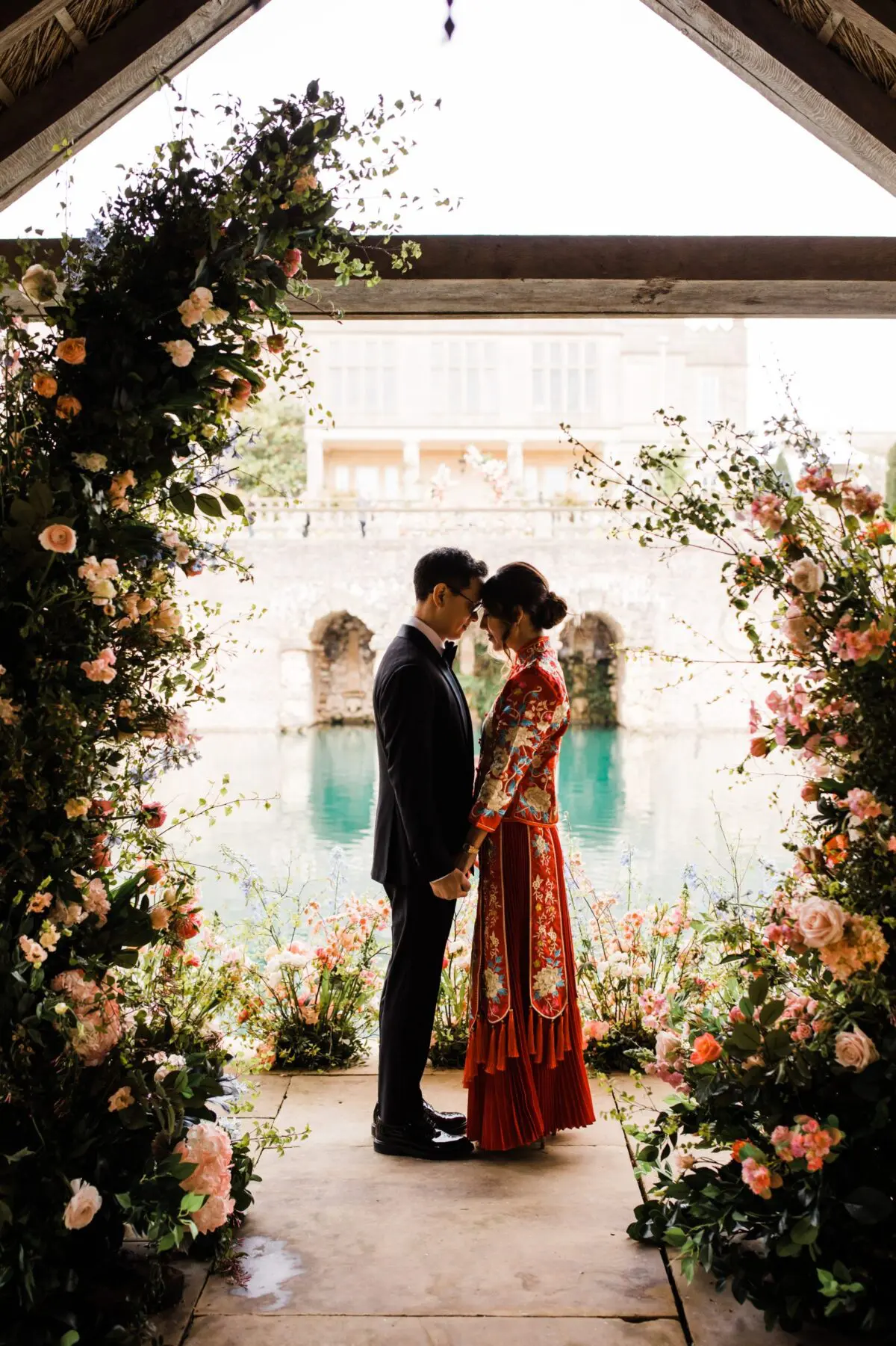 Bride and groom after chinese tea ceremony posing in boat house - wedding designer