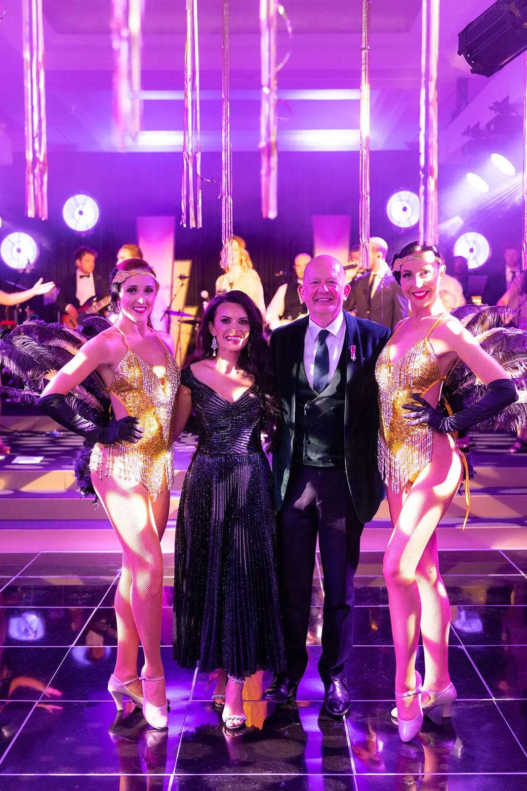 Man and woman standing with dancers | Luxury event planner