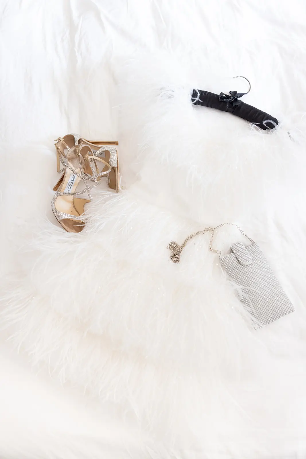 Brides party dress and accessories on bed