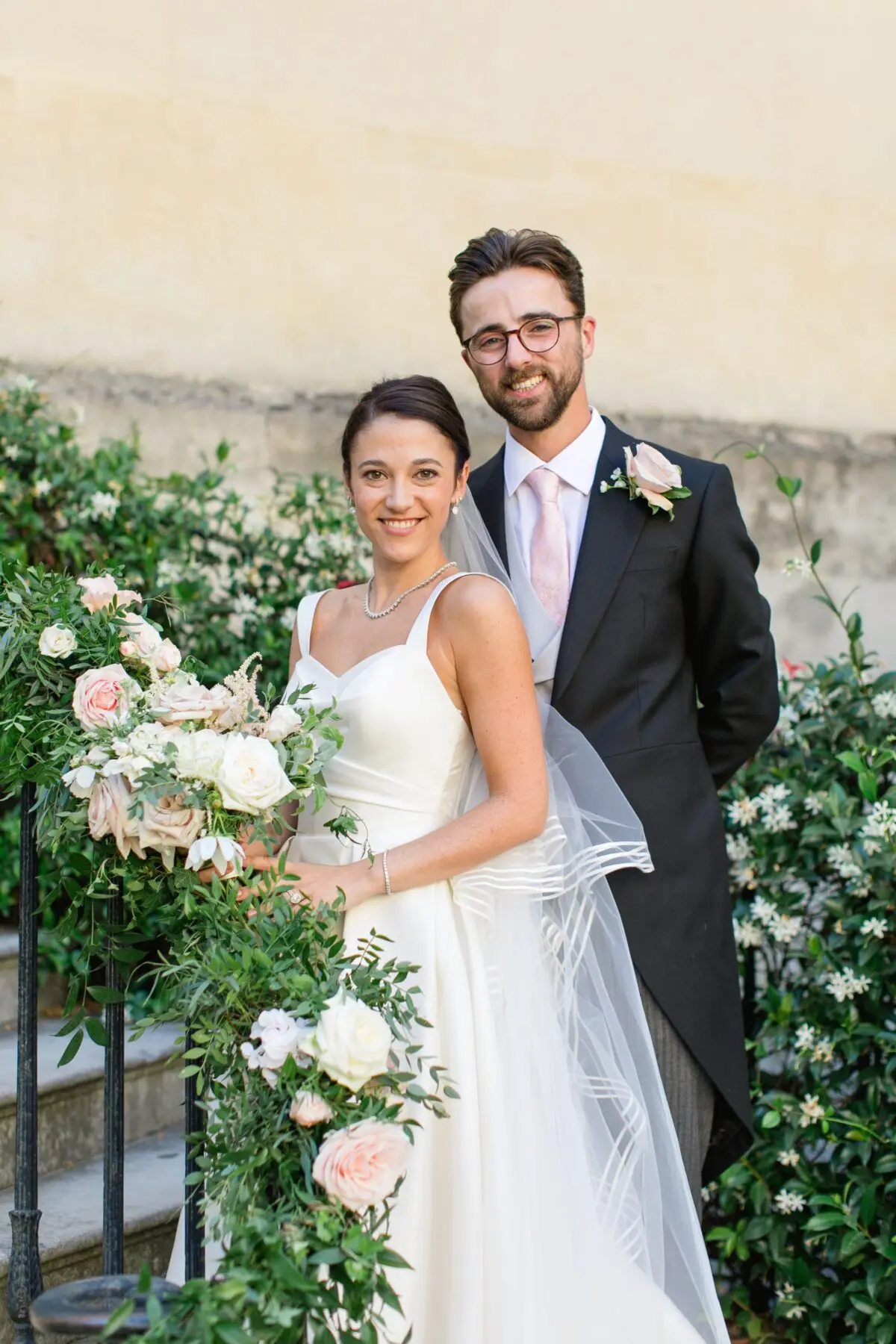 bride and groom posing on steps outside conservatory classic wedding dinner design in main house - Syon Park Wedding