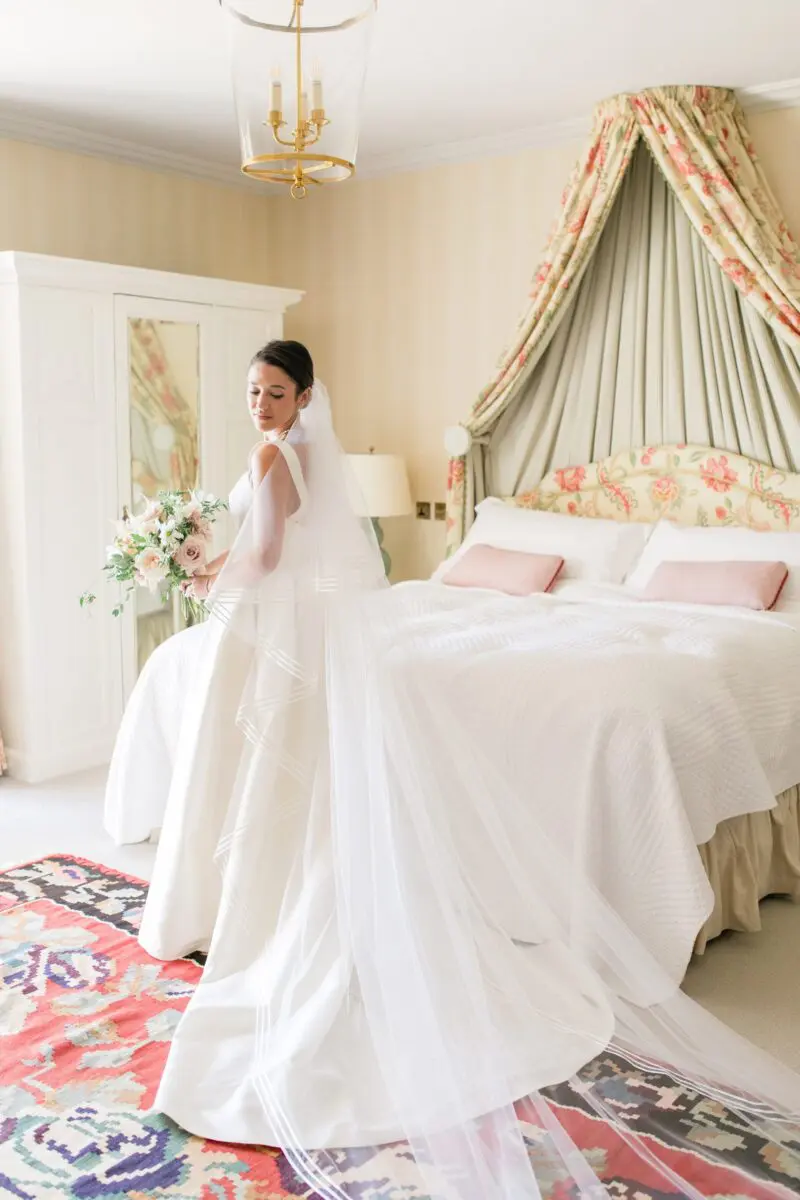 Bride in bedroom in wedding dress - Syon Park Wedding