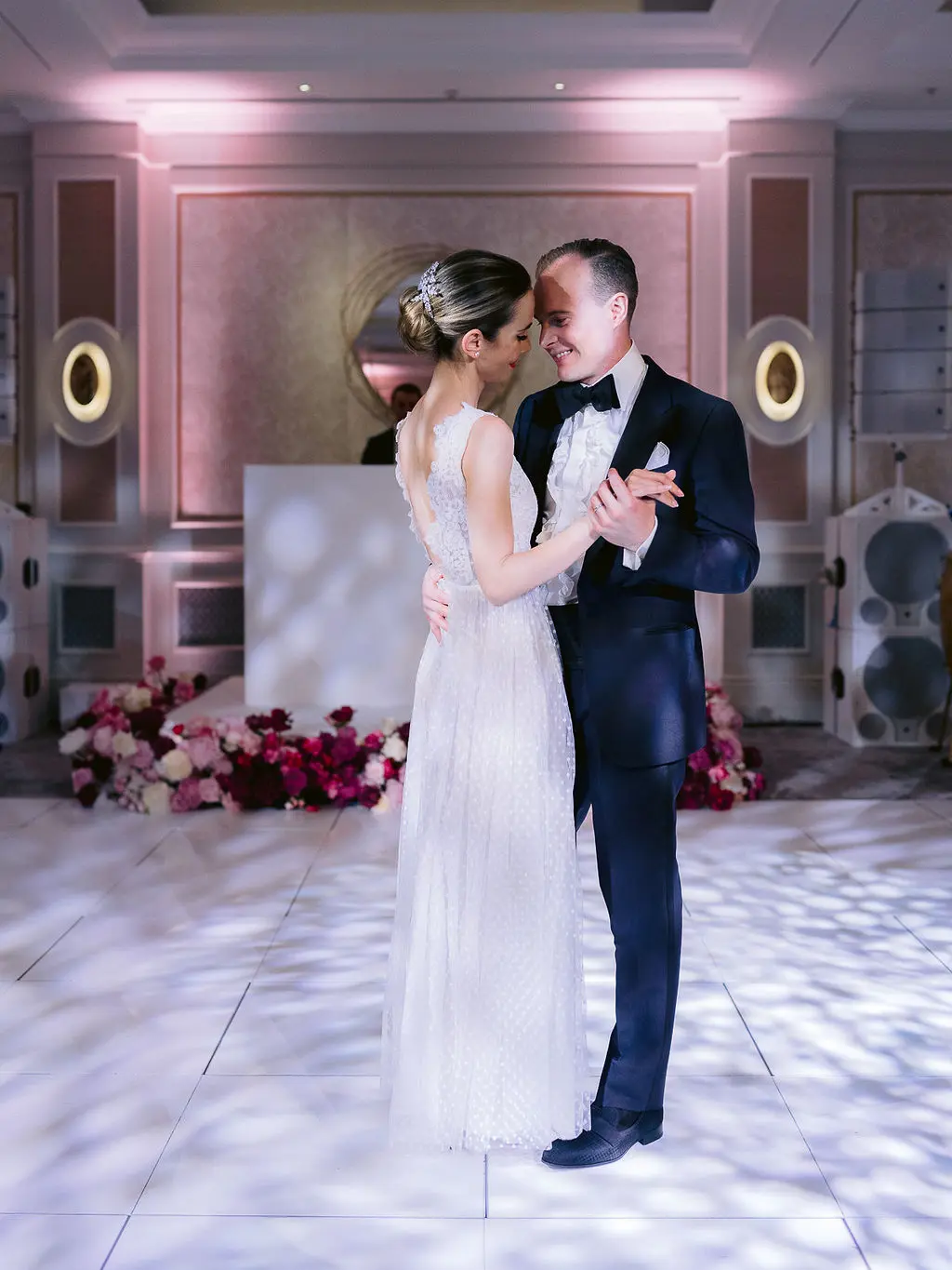 Bride and grooms first dance on white dance floor - Vogue wedding feature