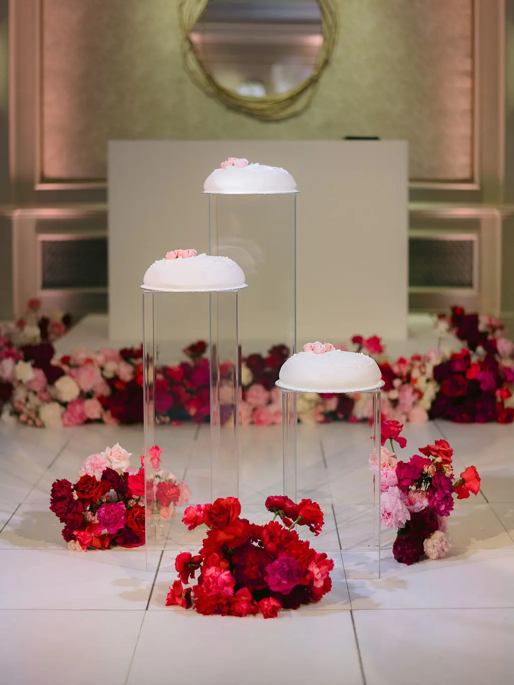 3 Swedish princess cakes on perspex plinths on white dance floor - Vogue wedding feature