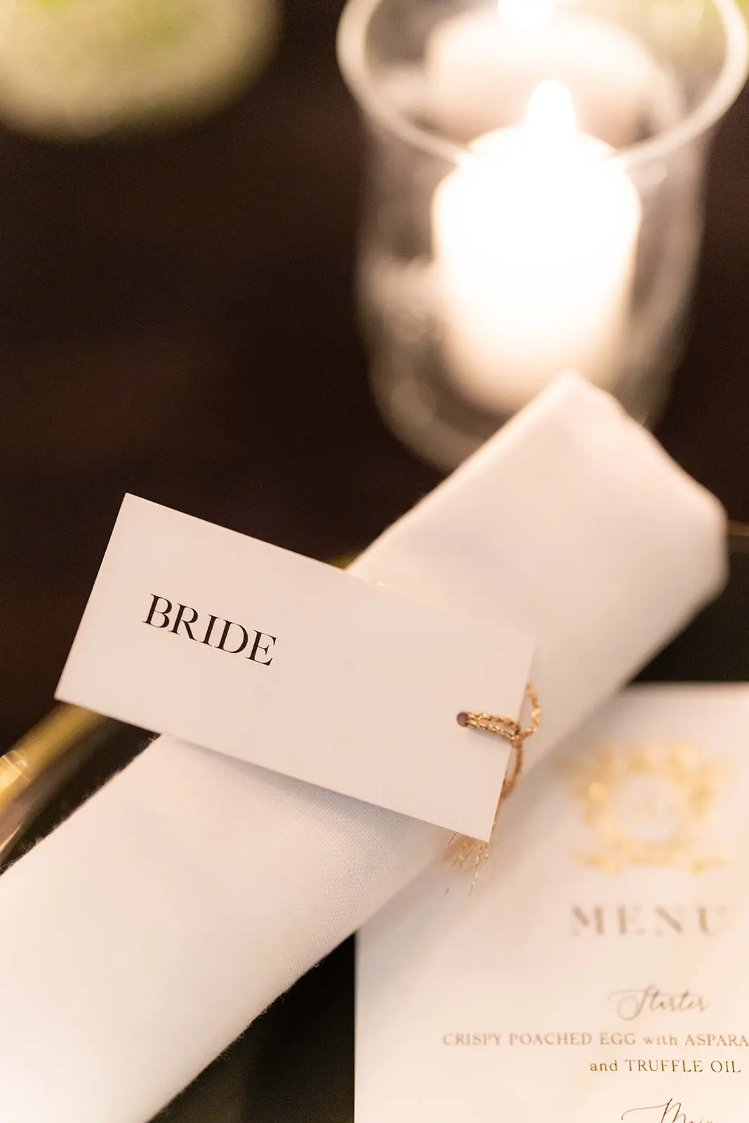 close up image of name tag wrapped about white napkin- monochrome wedding