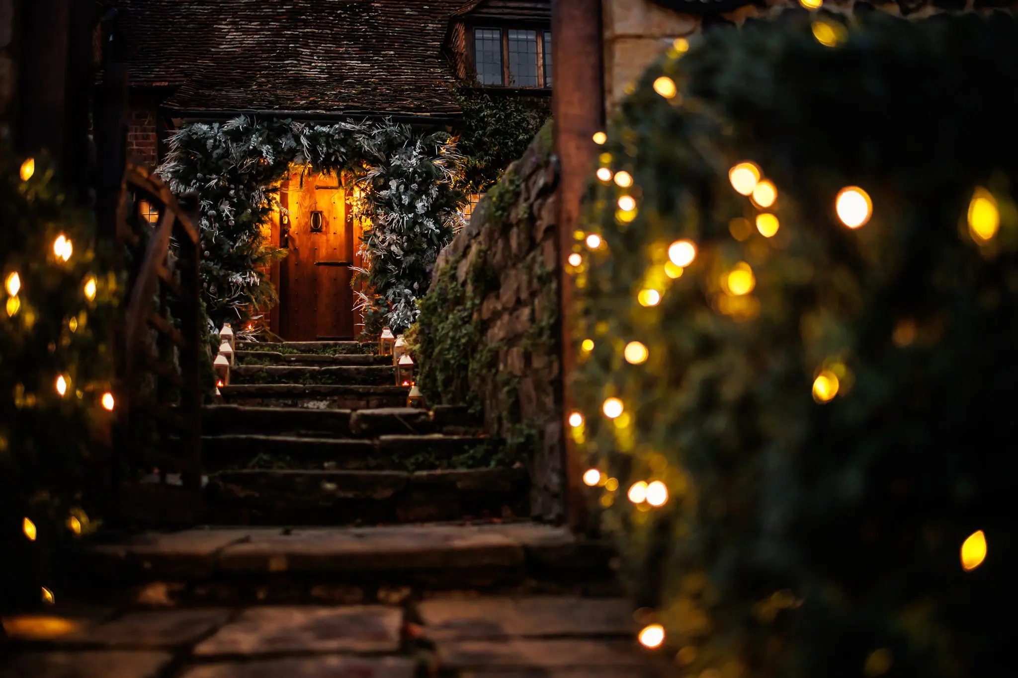 Evening image of large winter foliage arch on front door