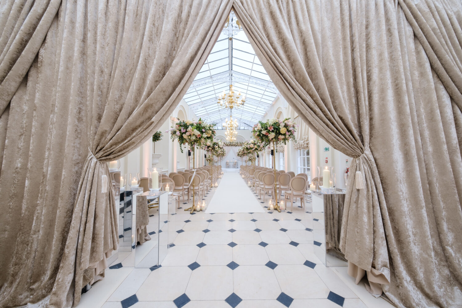 Spring wedding ceremony at Blenheim Palace with champagne coloured velvet draping