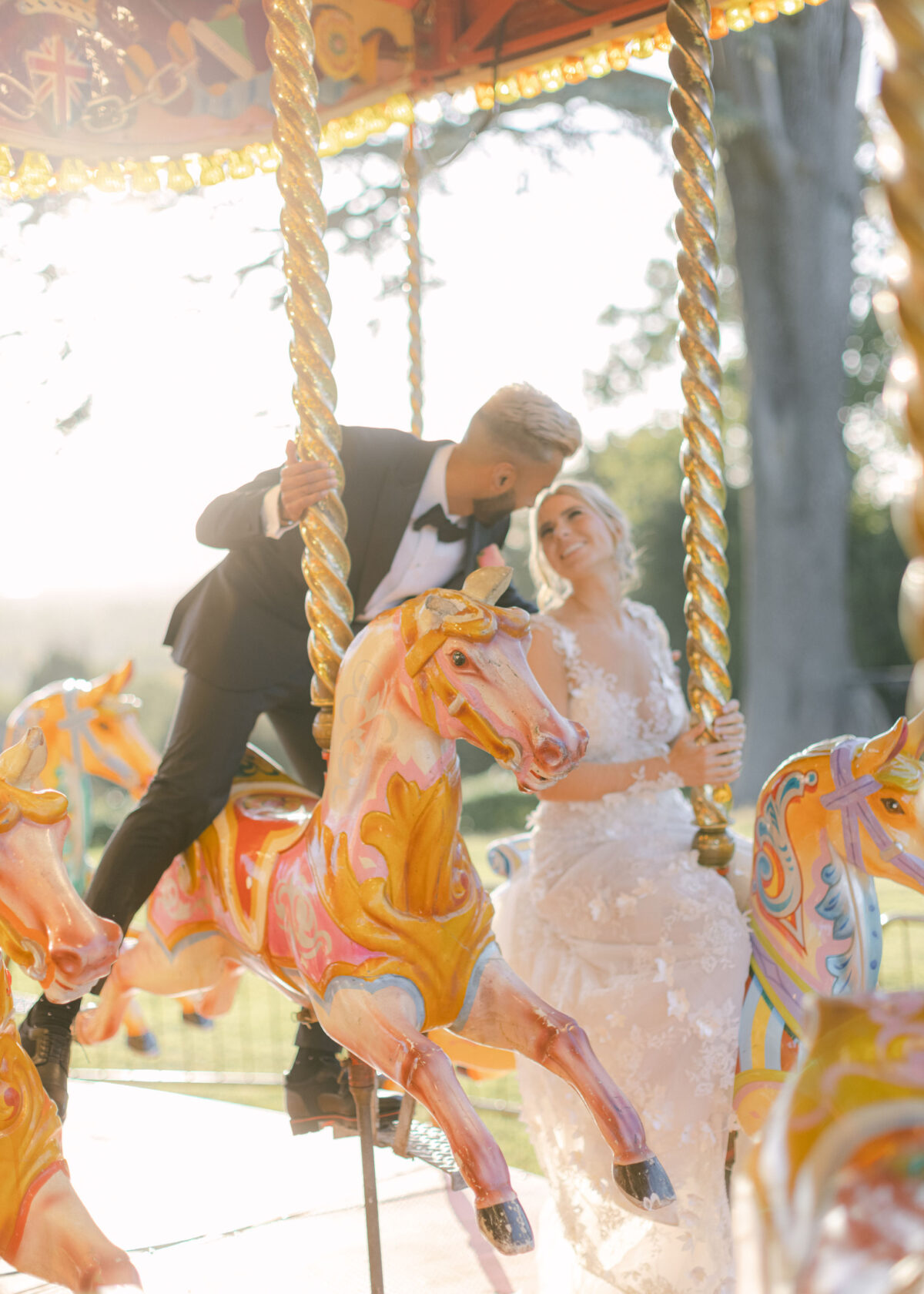 Bride and groom on carousel at wedding - Buckinghamshire wedding