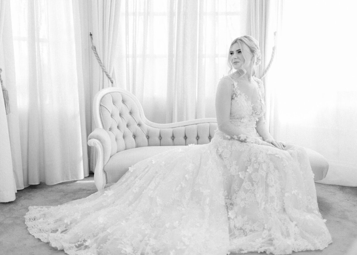 Black and white image of bride on sofa on the morning of wedding - Buckinghamshire wedding