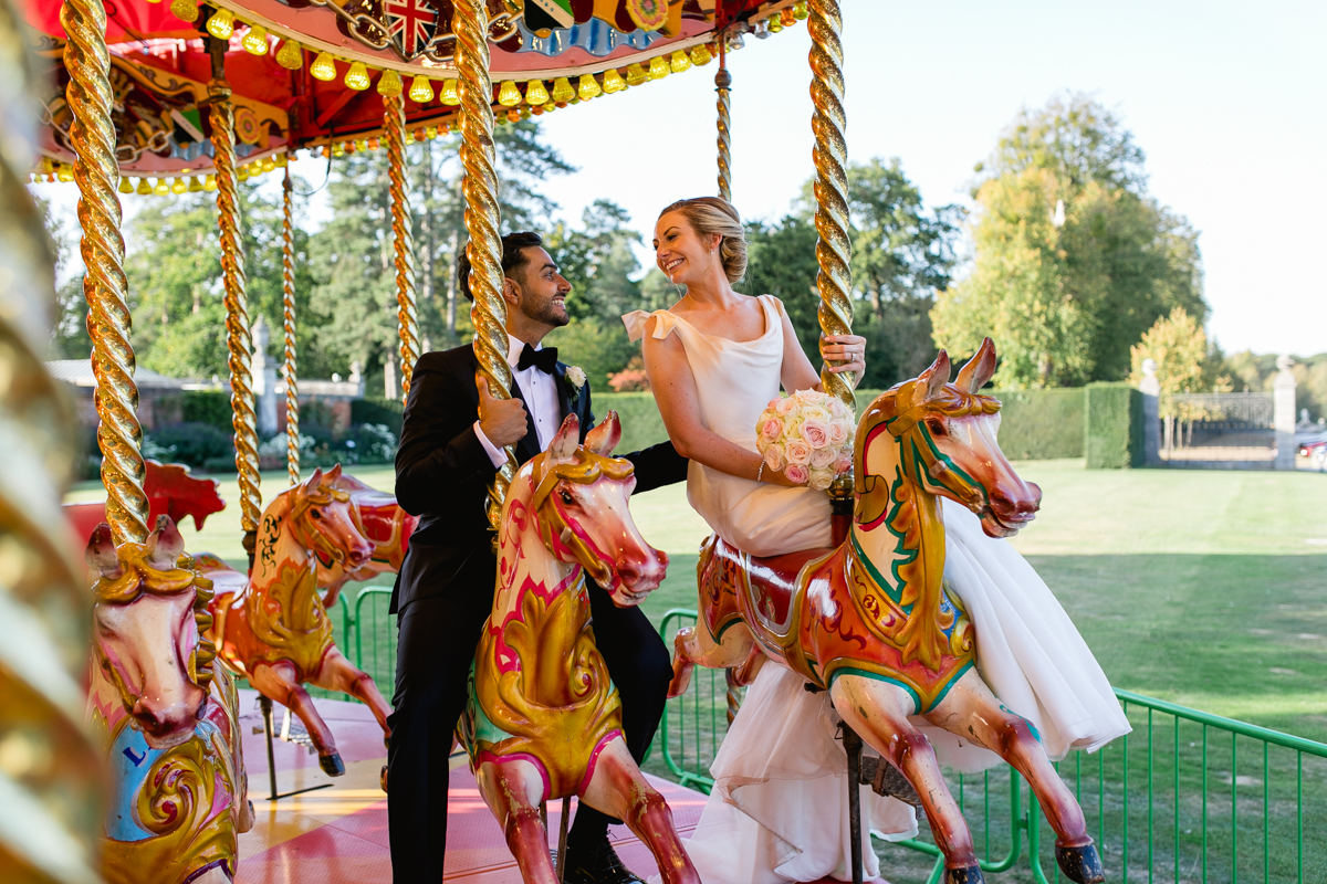 bride and groom on carousel at their wedding