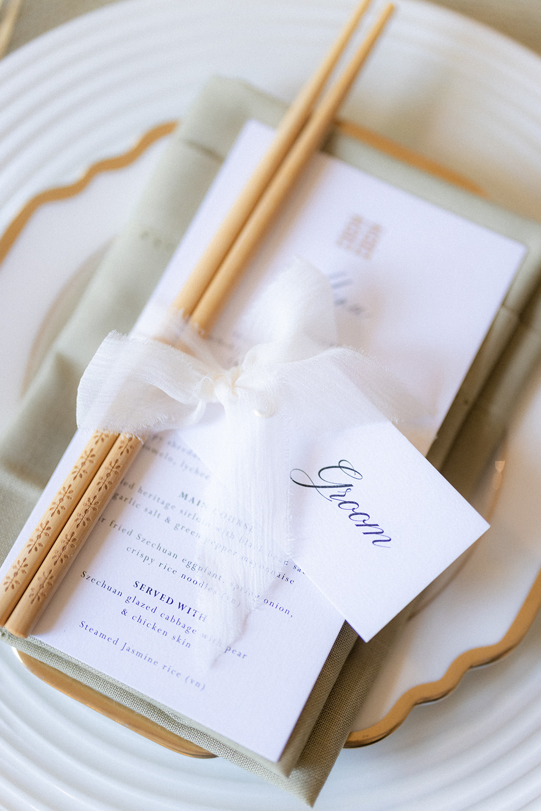 chopsticks on place setting with bespoke menu and name tag - wedding designer