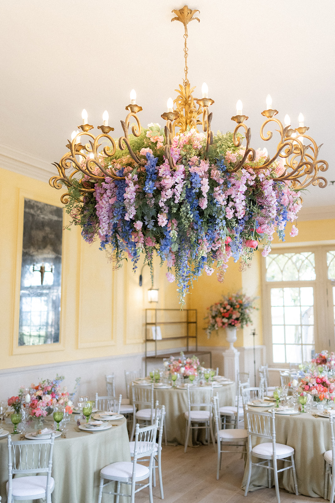 hanging flowers from chandelier in spring colours - wedding designer