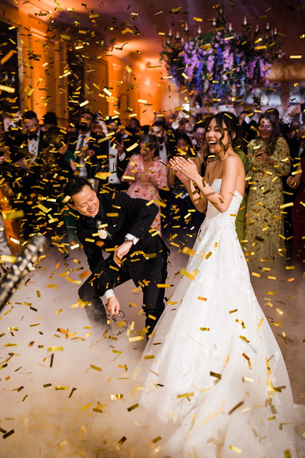 confetti cannons over bride and grooms first dance with low fog - wedding designer