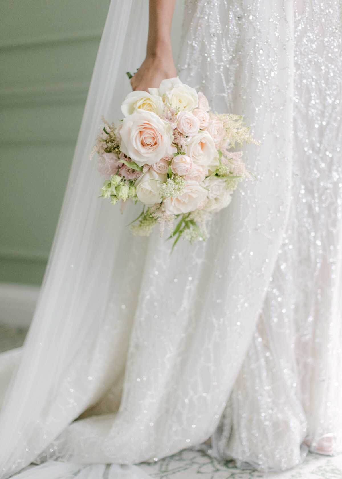 Close up image of bride in her Berta Bespoke wedding dress with bouquet of roses