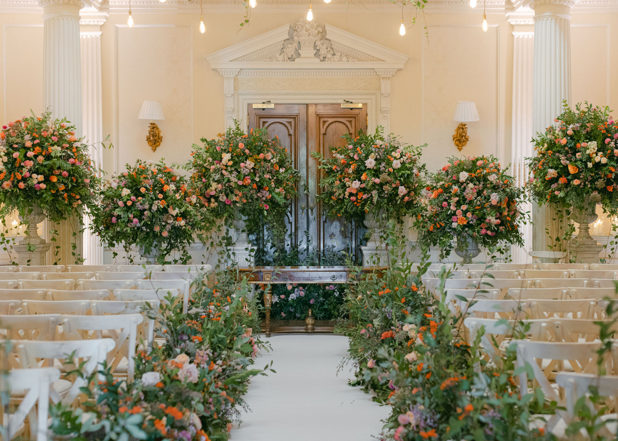 Ceremony set up at Hedsor House filled with a mass of autumnal flowers and foliage
