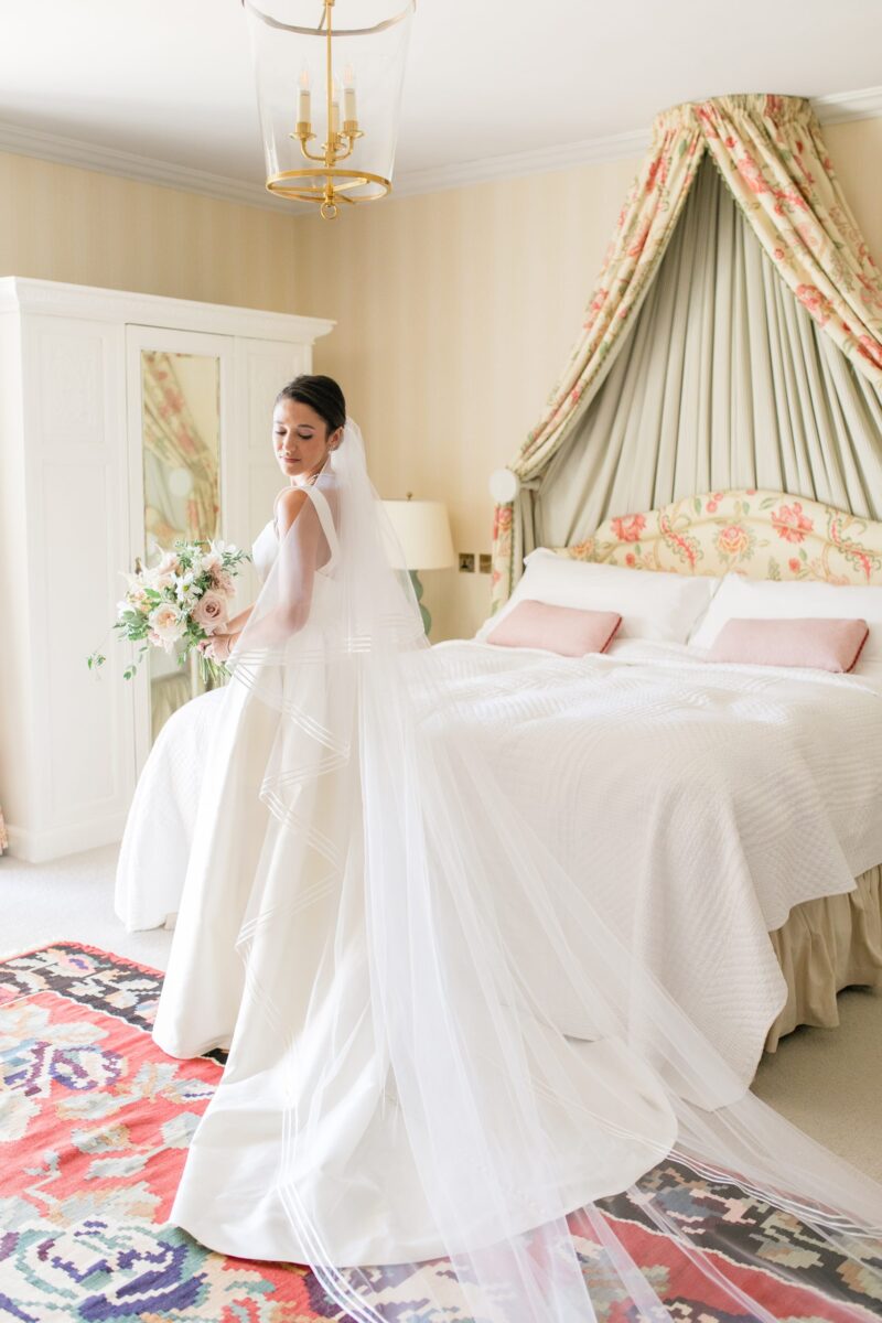Bride in bedroom in wedding dress - Syon Park Wedding