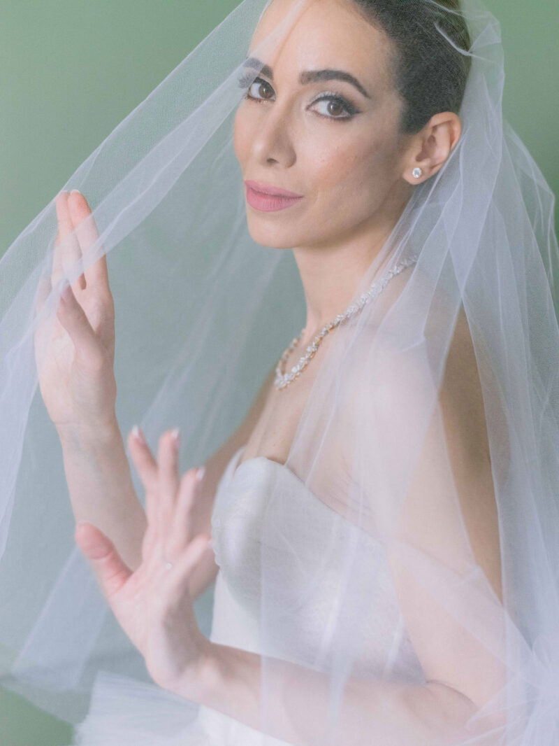Bride looking through her veil - Vogue wedding feature
